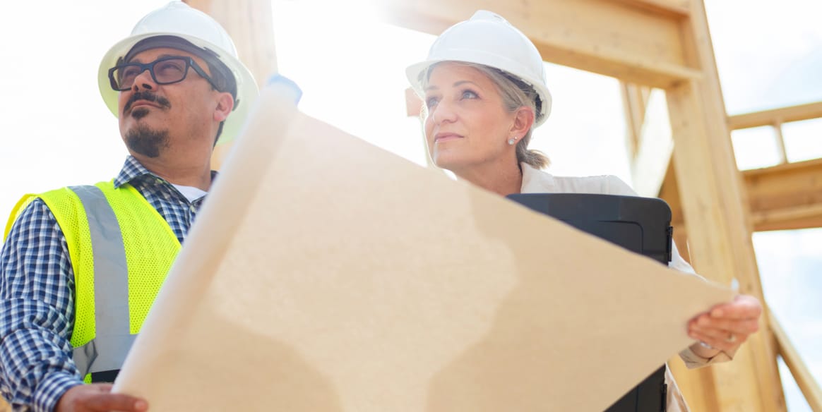 Two female executives discuss business in a corporate office.